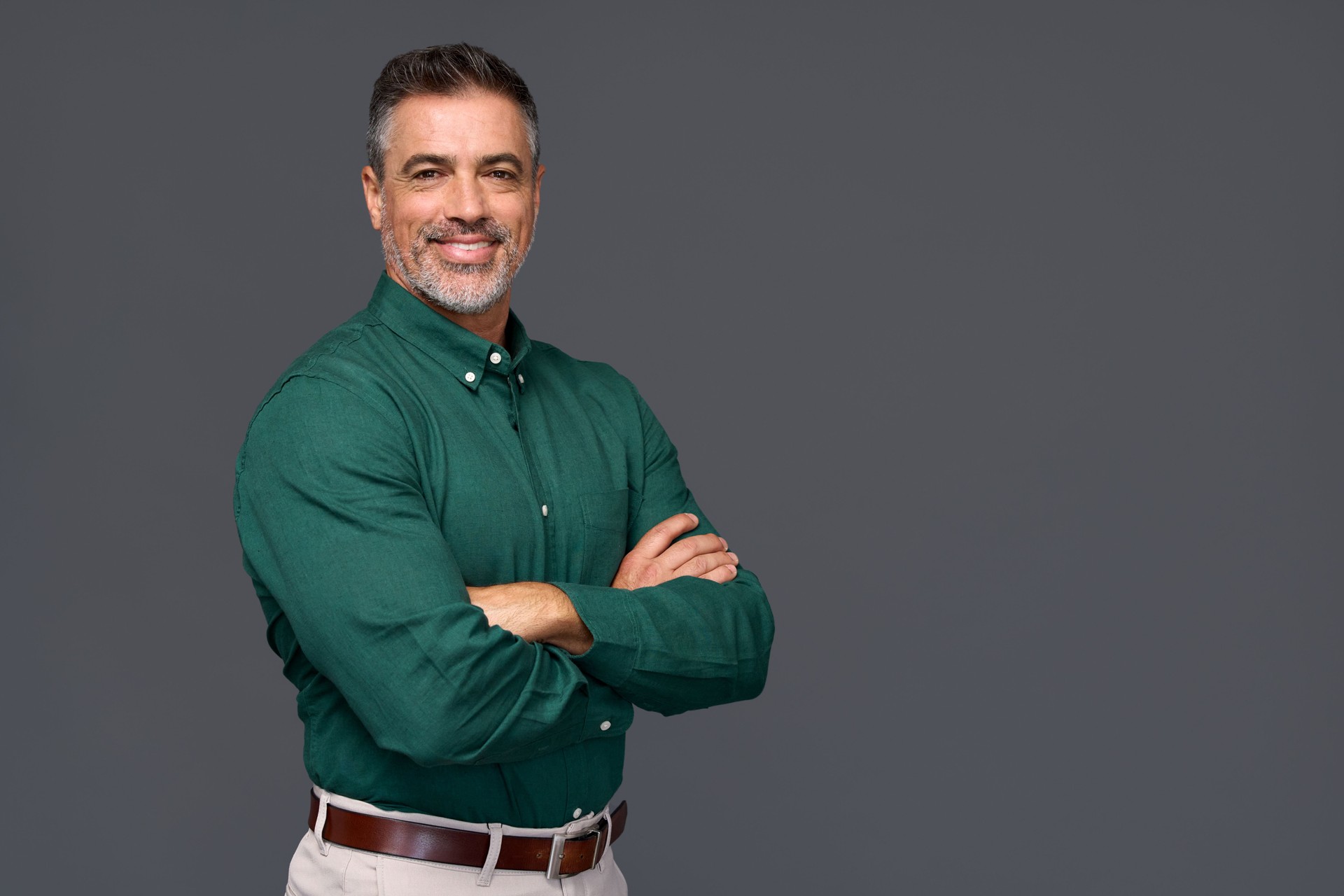 Portrait of elegant older business man isolated on gray background.